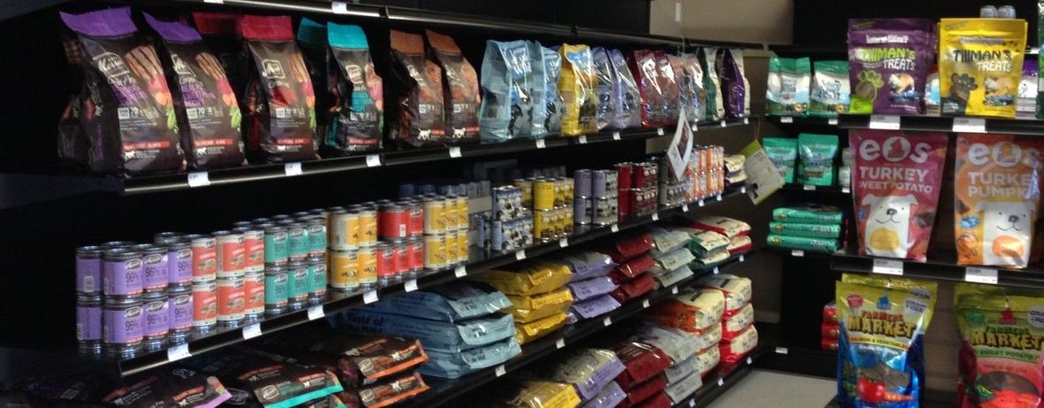 Shelves stocked with bags and cans of dog and cat food
